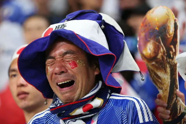 A Japan fan sheds tears of joy alongside a replica world cup trophy during the FIFA World Cup Qatar 2022 Group E match between Japan and Spain at Khalifa International Stadium on December 1, 2022 in Doha, Qatar. (Photo by Marc Atkins/Getty Images)