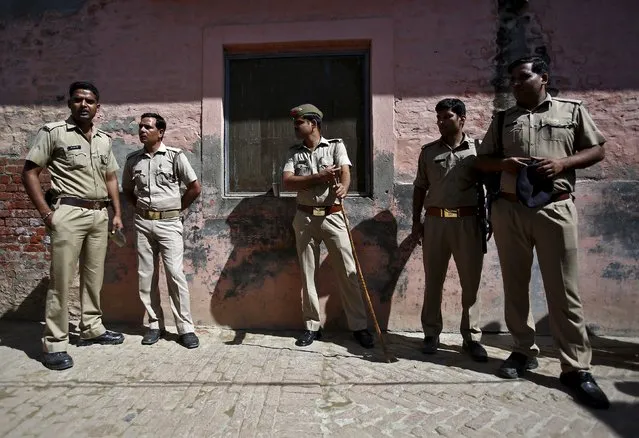 Indian policemen stand guard near the house of Akhalaq Saifi, who was killed by a mob, at Bisara village in Uttar Pradesh, India, October 2, 2015. The murder by a Hindu mob of a Muslim man rumored to have slaughtered a cow has thrown a spotlight on the hardline, polarizing agenda of some followers of Indian Prime Minster Narendra Modi, undermining his promise of development for all. (Photo by Anindito Mukherjee/Reuters)
