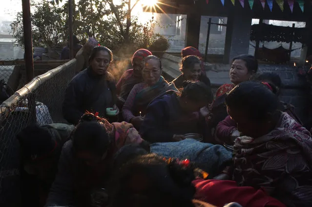 Nepalese devotees wait to offer prayer during Madhav Narayan Festival in Bhaktapur, Nepal, Tuesday, January 2, 2018. (Photo by Niranjan Shrestha/AP Photo)