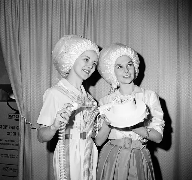 Tandem hair drying is possible with a new two-hood attachment for any electric hair dryer manufactured by Postcraft Co of Tucson, Ariz., shown in Chicago, January 27, 1965. A Y adapter permits two hoses to be attached to the dryer. (Photo by Edward Kitch/AP Photo)