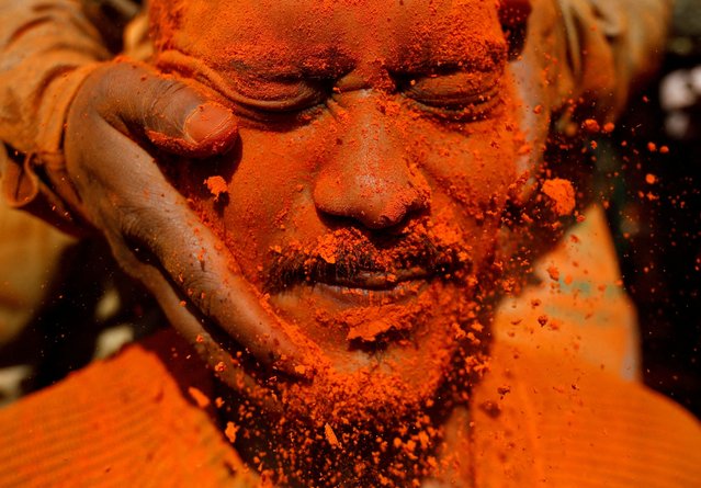 A devotee reacts as vermilion powder is applied on his face during the “Sindoor Jatra” vermilion powder festival to welcome the arrival of spring and Nepali new year at Thimi, in Bhaktapur, Nepal on April 15, 2025. (Photo by Navesh Chitrakar/Reuters)