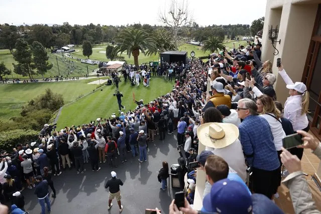 The gallery watches Tiger Woods, bottom left, as hits from the first tee during the first round of the Genesis Invitational golf tournament at Riviera Country Club, Thursday, February 16, 2023, in the Pacific Palisades area of Los Angeles. (Photo by Ryan Kang/AP Photo)