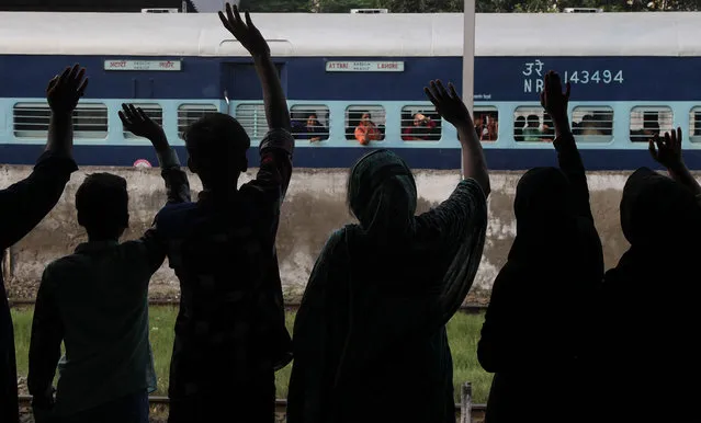 People see off passengers traveling to neighboring India at a railway station in Lahore, Pakistan, Monday, September 26, 2016. The Indian authorities allowed the operation of the Samjhota Express after refusing to permit the train to operate due to a probable security threat. Pakistan and India face tension after an attack earlier this month on an Indian military base in Indian Kashmir that left many soldiers dead. (Photo by K.M. Chaudary/AP Photo)
