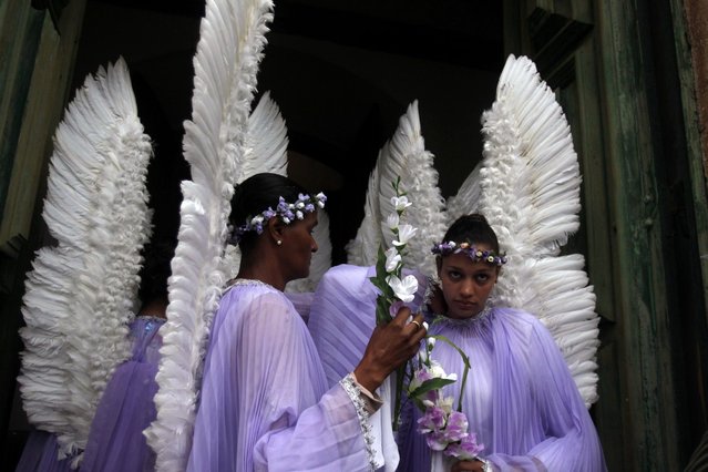 Worshippers dressed as angels wait to participate in the Easter Sunday procession in the historic city of Ouro Preto in the Brazilian state of Minas Gerais, March 31, 2013. (Photo by Pilar Olivares/Reuters)