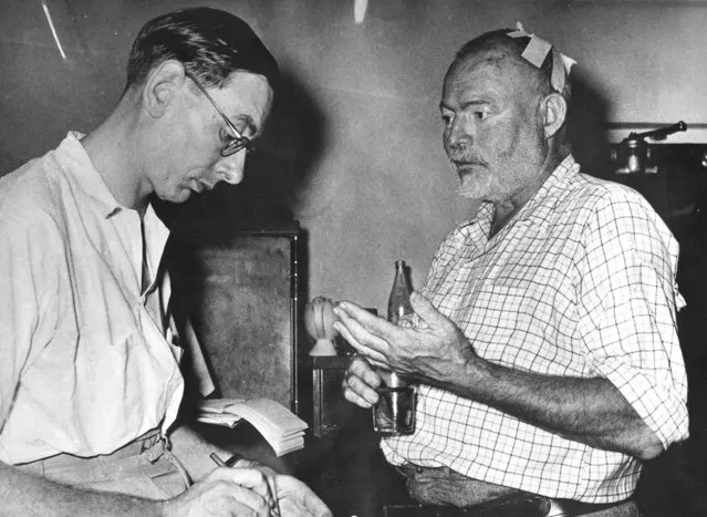 American Novelist Ernest Hemingway is interviewed by a newspaperman at Entebbe, January 25, 1954, after Hemingway and his wife had survived two plane crashs in the Uganda jungles while on a safari tour in Africa. Hemingway received only slight injuries. His wife cracked ribs. (Photo by AP Photo)