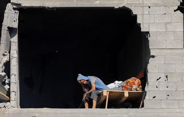 A Palestinian sits near the site of Israeli air strikes on houses, at al-Shati (Beach) refugee camp, in Gaza City, on September 12, 2025. (Photo by Ebrahim Hajjaj/Reuters)