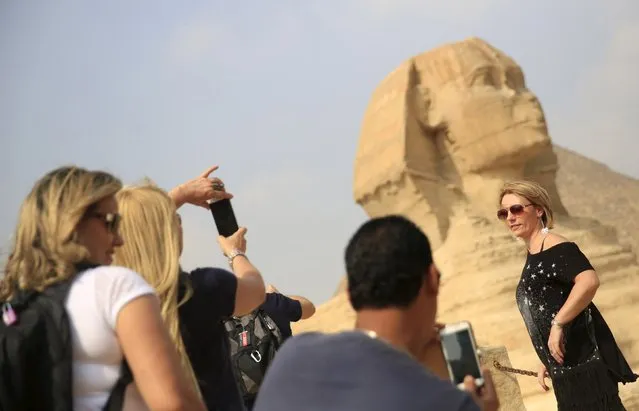 A tourist takes a picture in front of the Sphinx at the Giza Pyramids on the outskirts of Cairo, Egypt, November 8, 2015. (Photo by Amr Abdallah Dalsh/Reuters)