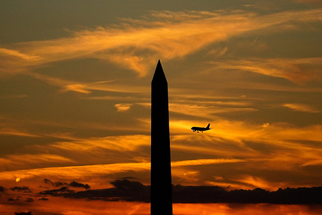 A commercial aircraft flies past the Washington Monument during a partial government shutdown in Washington, D.C., U.S., October 2, 2025. (Photo by Nathan Howard/Reuters)