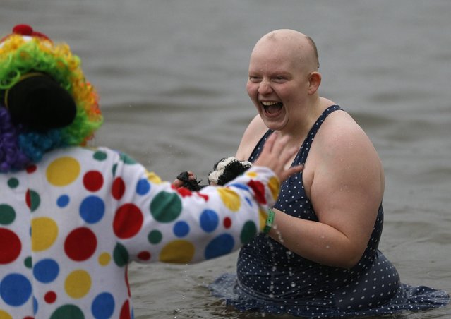 Swimmers in fancy dress laugh as they participate in the New Year's Day Loony Dook swim at South Queensferry, Scotland January 1, 2015. (Photo by Russell Cheyne/Reuters)
