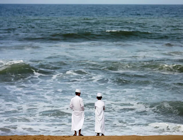 Two Muslim boys stand on the beach in the morning ahead of Eid al-Adha in Colombo, Sri Lanka September 8, 2016. (Photo by Dinuka Liyanawatte/Reuters)