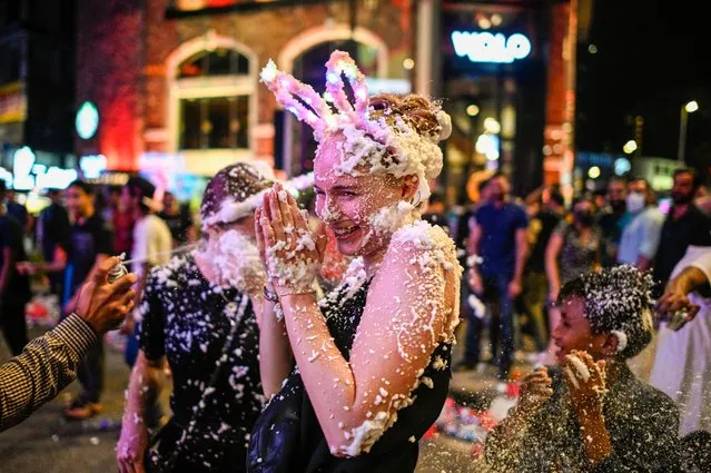A woman is sprayed with foam as she celebrates the New Year in Kuala Lumpur, Malaysia on January 1, 2020. (Photo by Mohd Rasfan/AFP Photo)
