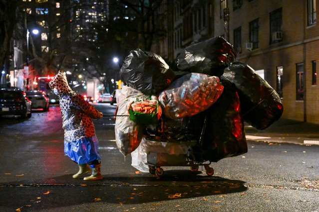 A person pulls a cart of recycling cans on December 2, 2025 in New York City. (Photo by Angela Weiss/AFP Photo)