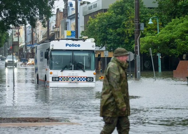A police van drives through the area after flooding for the second time in a month in Lismore, Australia on March 30, 2022. (Photo by Brendan Beirne/Rex Features/Shutterstock)