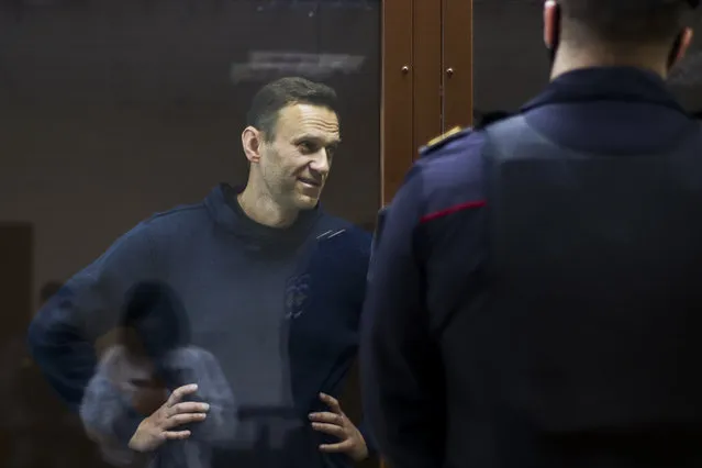 In this photo provided by the Babuskinsky District Court, Russian opposition leader Alexei Navalny stands in a cage during a hearing on his charges for defamation, in the Babuskinsky District Court in Moscow, Russia, Friday, February 5, 2021. Russian opposition leader Alexei Navalny appeared in a Moscow court on Friday for the second time this week, this time on a charge of slandering a World War II veteran. The politician, who was ordered earlier this week to serve two years and eight months in prison, slammed the hearing as a “disgusting PR trial” intended by the Kremlin to disparage him. (Photo by Babuskinsky District Court Press Service via AP Photo)