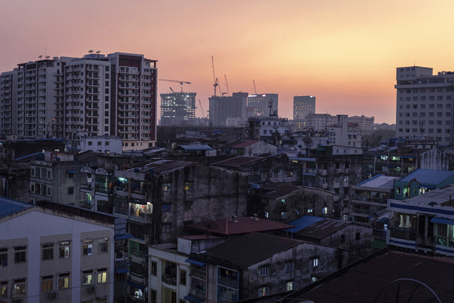 Skylines of Mingalar Taung Nyunt Township are seen at dusk in Yangon, Myanmar, Monday, February 1, 2021, after the military staged a coup and detained senior politicians including Nobel laureate and de facto leader Aung San Suu Kyi. (Photo by @benjaminsmall via AP Photo)