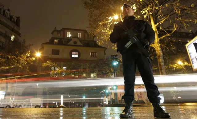 A policeman stands guard over the Bataclan concert hall in Paris, France, November 12, 2016, where rock star Sting will perform a special reopening concert one year after the deadly Paris attacks. (Photo by Christian Hartmann/Reuters)