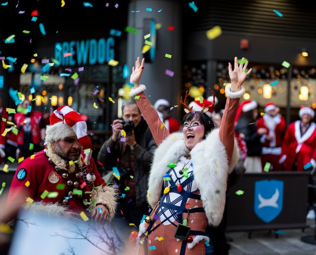 People dressed as Santa take part in the London Santacon Christmas parade at the Floating Pocket Park in London on Saturday, December 14, 2024. (Photo by Jordan Pettitt/PA Images via Getty Images)