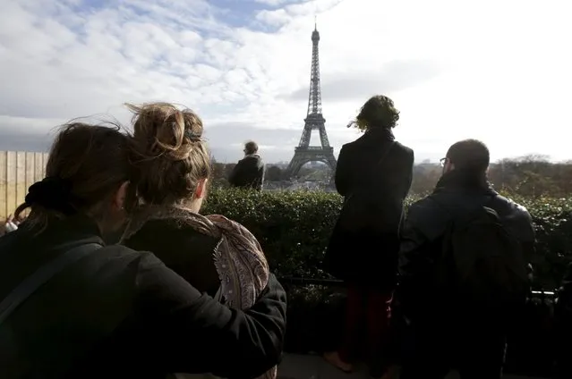 People observe a minute of silence at the Trocadero in front the Eiffel Tower to pay tribute to the victims of the series of deadly attacks in Paris, France, November 16, 2015. (Photo by Philippe Wojazer/Reuters)