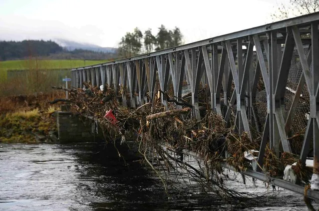 A footbridge lies littered with debris following flooding at Newton Stewart in Scotland, Britain December 31, 2015. Torrential rain and gale force winds have battered northern Britain cutting power to thousands of homes and forcing some to evacuate flooded streets in the third major storm in a month. (Photo by Darren Staples/Reuters)
