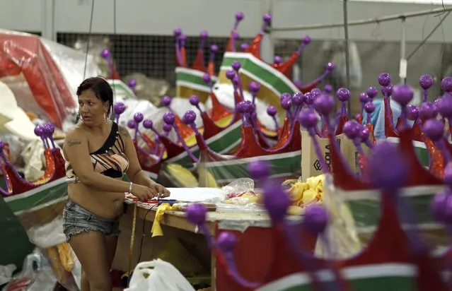 A worker sews a carnival costume at the Grande Rio samba school, in preparation for the annual carnival parade, in Rio de Janeiro February 10, 2015. The Rio de Janeiro Carnival will be held from February 13 to February 17. (Photo by Pilar Olivares/Reuters)