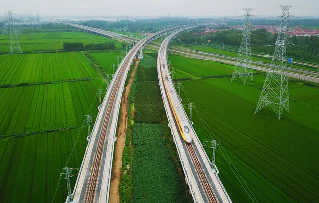 A newly launched bullet train undergoes a test run between Yancheng in Jiangsu province and Lianyungang in China's eastern Jiangsu province on August 31, 2018. (Photo by AFP Photo/Stringer)