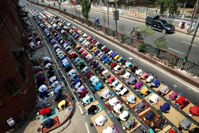 Muslims take part in Friday prayer as part of the holy fasting month of Ramadan on the street in front of a mosque amid the coronavirus disease (COVID-19) pandemic, in Dhaka, Bangladesh, April 16, 2021. (Photo by Mohammad Ponir Hossain/Reuters)