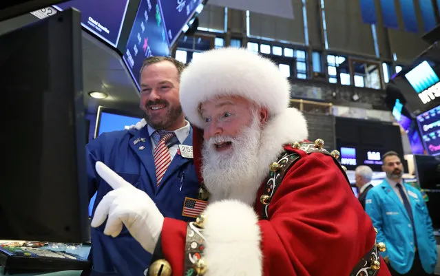 Santa Claus pays a visit on the floor at the New York Stock Exchange (NYSE) in New York, U.S., November 21, 2018. (Photo by Brendan Mcdermid/Reuters)
