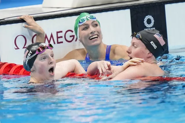 Lydia Jacoby of the United States, left, celebrates winning the 100m breaststroke final with Lilly King of the United States, as Tatjana Schoenmaker looks on during Day 4 of swimming at the Tokyo Aquatics Centre at the Tokyo 2020 Olympic Games on Tuesday, July 27. 2021. (Photo by Toni L. Sandys/The Washington Post)