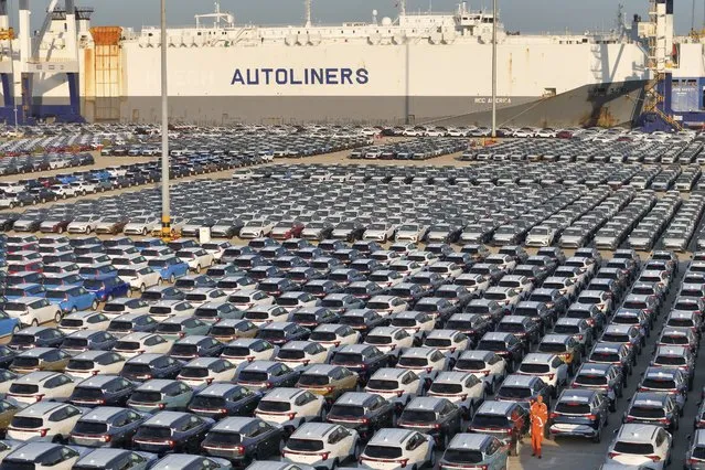 This aerial view shows new cars waiting to be exported at a dockyard in Yantai in eastern China's Shandong province Thursday, November 02, 2023. China's imports rose in October while exports fell for a sixth straight month compared with a year earlier, partly due to lower export prices. (Photo by Chinatopix via AP Photo)