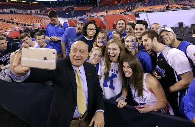 Broadcaster Dick Vitale poses for a photo with Duke fans before the NCAA Final Four college basketball tournament championship game between Wisconsin and Duke Monday, April 6, 2015, in Indianapolis. (Photo by David J. Phillip/AP Photo)