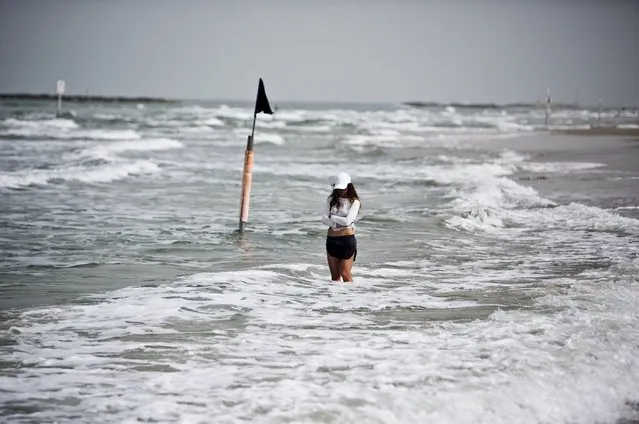 A beach-goer stands still as a two-minute siren marking Holocaust Remembrance Day is sounded in Tel Aviv April 16, 2015. (Photo by Nir Elias/Reuters)