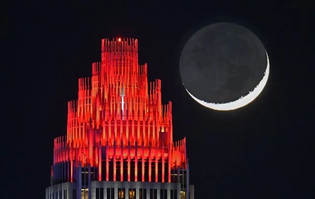 First New moon rises over the Bank of America Corporate Center in Queen City, North Carolina, United States on January 13, 2024. (Photo by Peter Zay/Anadolu via Getty Images)