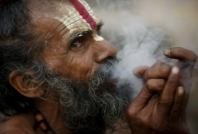 A Hindu holy man, or sadhu, smokes marijuana in a chillum on the premises of Pashupatinath Temple in Kathmandu, Nepal March 6, 2016. (Photo by Navesh Chitrakar/Reuters)