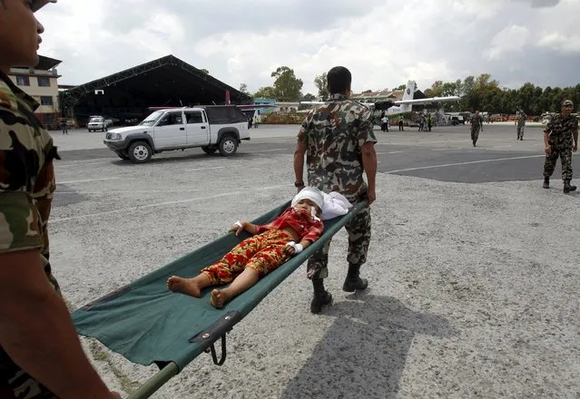 Indian army soldiers carry an injured child, who was wounded in Saturday's earthquake, after being evacuated from Trishuli Bazar to the airport in Kathmandu, Nepal, April 27, 2015. (Photo by Jitendra Prakash/Reuters)