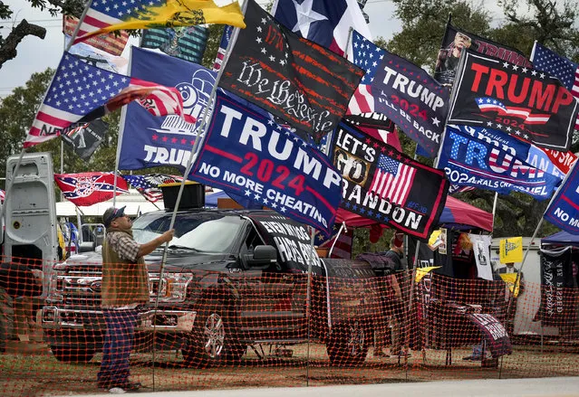 Rudy Martinez, of San Antonio, sets up his flags for sale at the Take Our Border Back Convoy in Dripping Springs, Texas, on Thursday February 1, 2024. (Photo by Jay Janner/Austin American-Statesman via AP Photo)