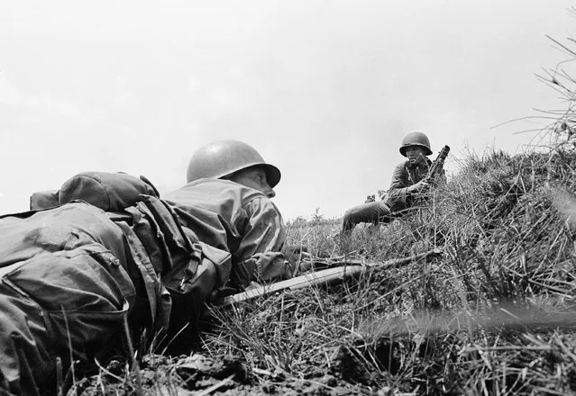 In this April 5, 1965 file photo, Capt. Donald R. Brown crouches on the ground in Saigon, waiting for the order for attack across an open field against Vietcong positions in a treeline from where enemy combatants with automatic weapons had briefly pinned down the HQ company of the 2nd Battalion, 46 Regiment. (Photo by AP Photo)