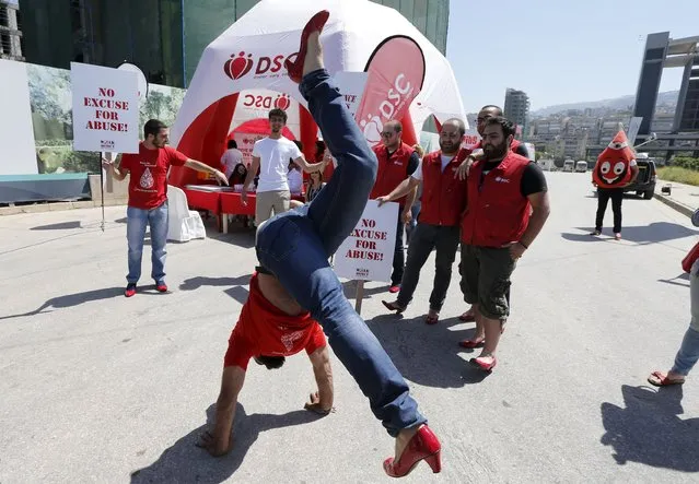 A man wearing high-heeled shoes kicks his legs in the air during a march to protest against sexual violence against women in a fundraising event called “Walk A Mile In Her Shoes” in Beirut April 26, 2015. (Photo by Mohamed Azakir/Reuters)