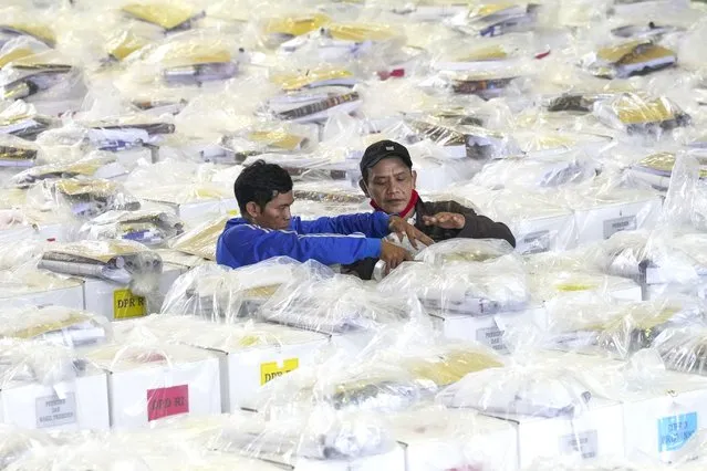 Workers prepare ballot boxes to be distributed to polling stations ahead of the Feb. 14 election, in Jakarta, Indonesia, Tuesday, February 13, 2024. Indonesia, the world's third-largest democracy, will open its polls on Wednesday to nearly 205 million eligible voters in presidential and legislative elections, the fifth since Southeast Asia's largest economy began democratic reforms in 1998. (Photo by Tatan Syuflana/AP Photo)