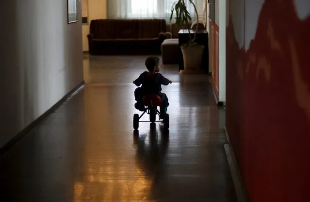 A boy rides his tricycle at the accommodation for migrants “Spree Hotel” in Bautzen, Germany, March 22, 2016. (Photo by Ina Fassbender/Reuters)