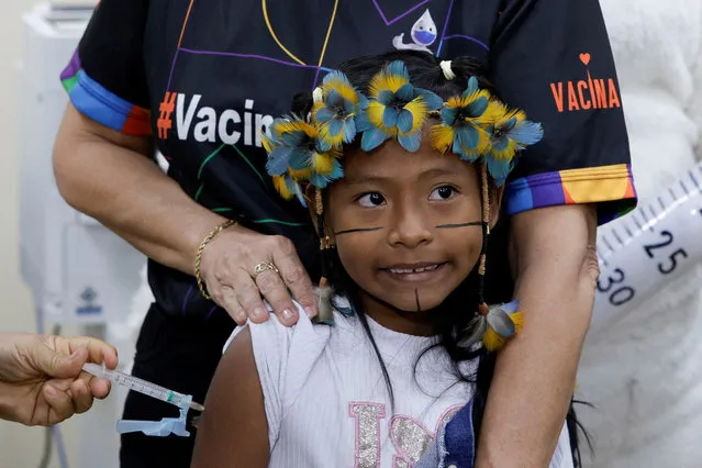 Anita Jose Rodrigues, 10, receives the dengue vaccine Qdenga during a vaccination campaign, at the Parque das Tribos in Manaus, Brazil on February 22, 2024. (Photo by Bruno Kelly/Reuters)