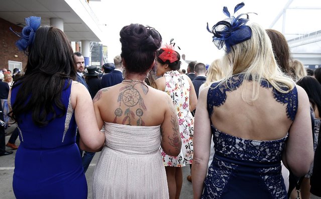 Racegoers leave after Ladies Day of the Crabbie's Grand National Festival at Aintree Racecourse on April 8, 2016 in Liverpool, England. (Photo by Andrew Yates/Reuters/Livepic)