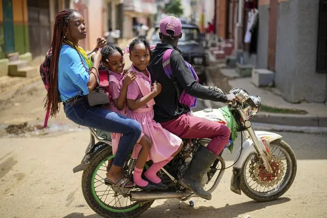 People ride on a motorcycle in Cap-Haitien, Haiti, Wednesday, April 17, 2024. (Photo by Ramon Espinosa/AP Photo)