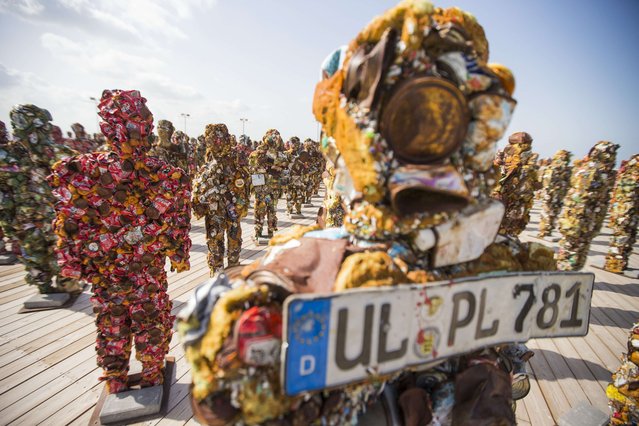 A general view shows sculptures made of waste material titled “Trash People” by German Artist HA Schult (unseen), on April 2, 2014 in Ariel Sharon Park, in the suburbs of Tel Aviv. Hundreds of human-size figures constructed from 20 tons of recycled material, including iron, glass, computer parts, cans and more, will dominate the sky line of Tel-Aviv city and be placed in the park. (Photo by Jack Guez/AFP Photo)