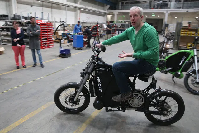 eRockit founder and CEO Stefan Gulas explains the functions of an eRockit high-powered electric bicycle to visiting journalists at the company's production site on April 1, 2014 in Berlin, Germany. The eRockit boasts an 8,000 watt electric motor that can propel the vehicle at over 80 km/h. The rider controls speed and acceleration through the motion of the pedals, giving the bike a bicycle-like feel but with a big kick. Gulas says the bike retails for between EUR 13,000 and EUR 16,000, depending on the battery capacity and that he expects production next year to reach 300 bikes annually. (Photo by Sean Gallup/Getty Images)