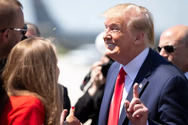 US President Donald Trump reacts when a member of the media asks him why he does not like Paul Ryan after steping off Air Force One upon arrival at General Mitchell International Airport in Milwaukee, Wisconsin on July 12, 2019. Trump will be in Milwaukee to visit an aerospace company and attend a fundraiser. (Photo by Colin Boyle/Milwaukee Journal Sentinel)