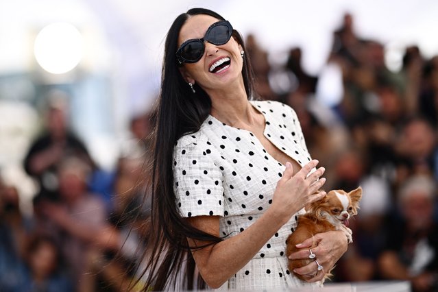 American actress Demi Moore holds her Chihuahua dog named Pilaf as she pose during a photocall for the film “The Substance” at the 77th edition of the Cannes Film Festival in Cannes, southern France, on May 20, 2024. (Photo by Loic Venance/AFP Photo)