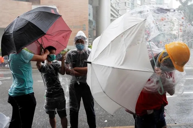 Protesters gather outside the Eastern Courts to support the arrested anti-extradition bill protesters who face rioting charges, as the typhoon Wipha approaches in Hong Kong, China on July 31, 2019. (Photo by Tyrone Siu/Reuters)