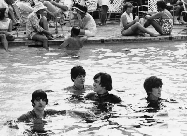 The Beatles, from left Ringo Starr, John McCartney, John Lennon, and George Harrison, take a dip in the pool in Nassau, Bahamas on February 23, 1965, with their clothes on while filming a movie. (Photo by Harold Valentine/AP Photo)