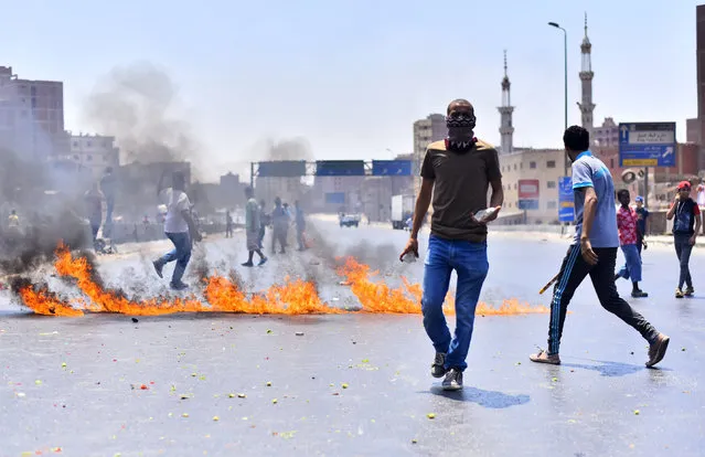 Muslim brotherhood supporters throw rocks at a protest to mark the second anniversary of the military's overthrow of Islamist President Mohammed Morsi, Giza, Egypt, Friday, July 3, 2015. (Photo by Amr Sayed/AP Photo)