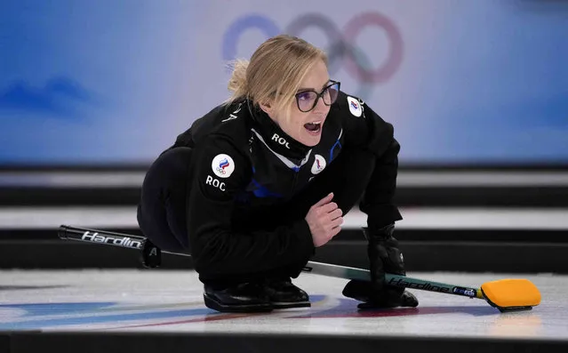 Galina Arsenkina of the Russian Olympic Committee, directs her teammates, during the women's curling match against Britain, at the 2022 Winter Olympics, Thursday, February 17, 2022, in Beijing. (Photo by Nariman El-Mofty/AP Photo)